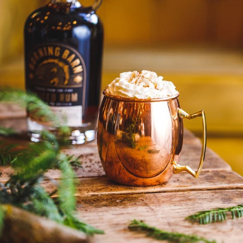 Hot chocolate in gold mug with whipped cream