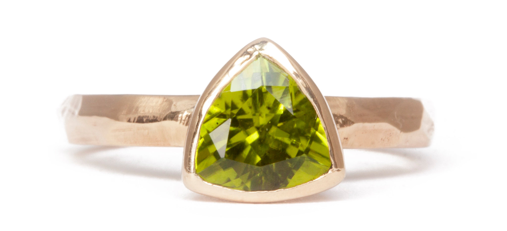 The Fairmined Arizona Peridot Trillion-Cut Carved Solitaire on white background