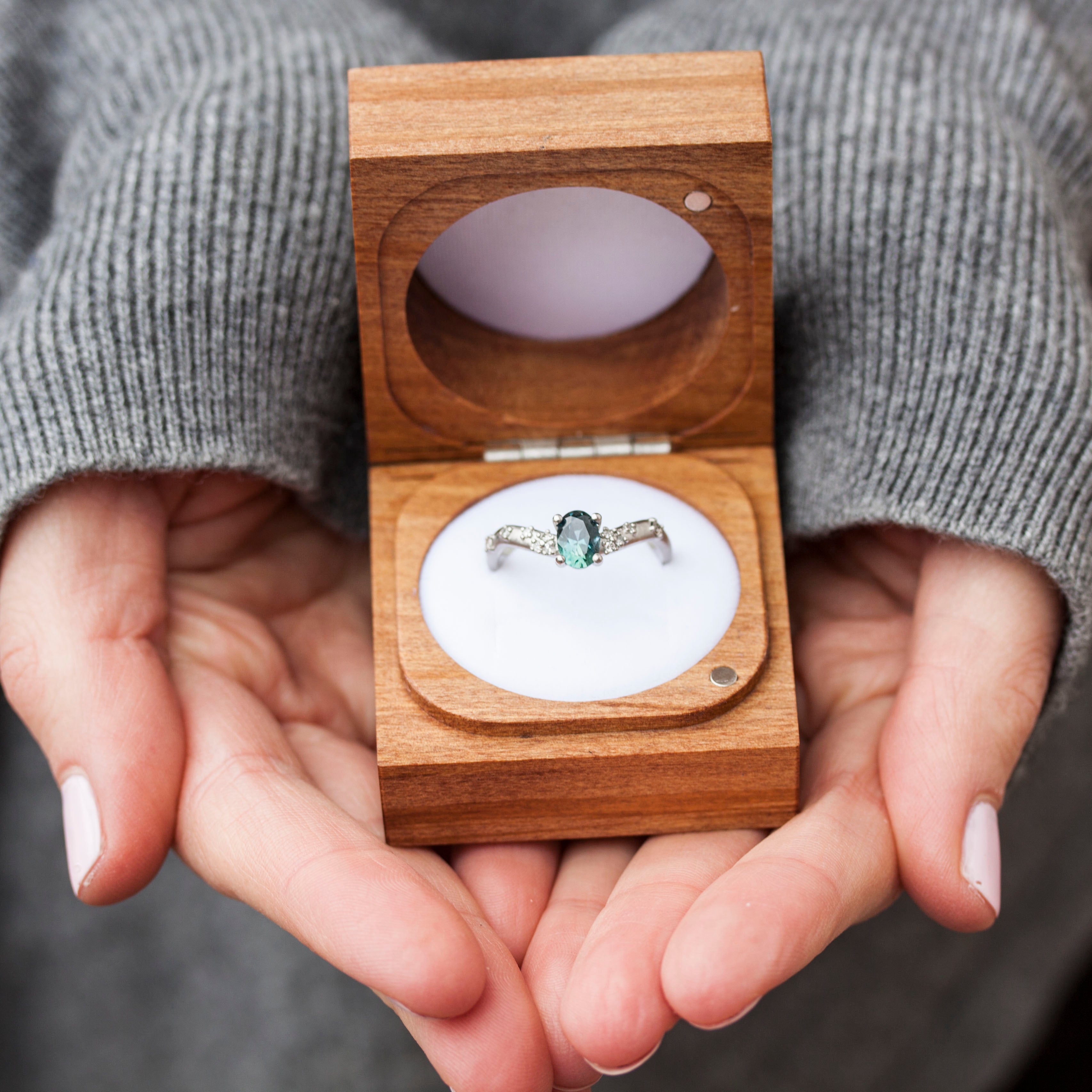 Wooden Ring Box with sapphire ring, held in hands
