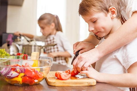 Boy using a knife to cook in the kitchen