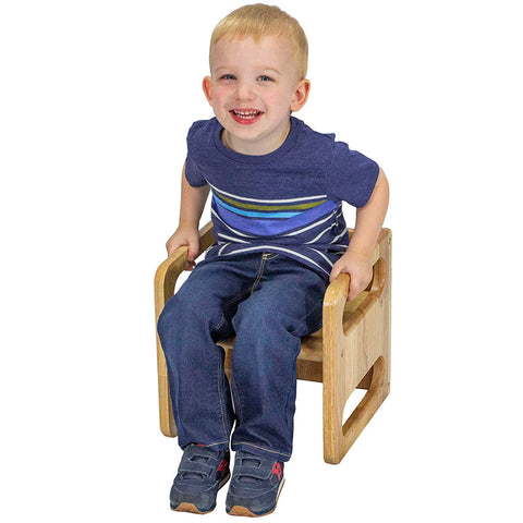 Toddler sitting on a cube chair