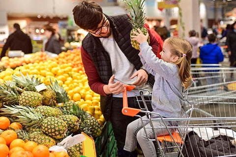 Dad and girl grocery shopping