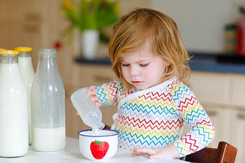 Kid pouring in kitchen