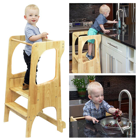 Child standing on a kids kitchen stool washing hand and helping cook