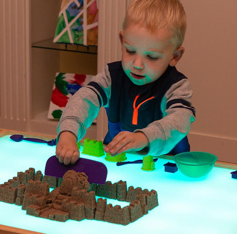 Kinetic sand castle on light table