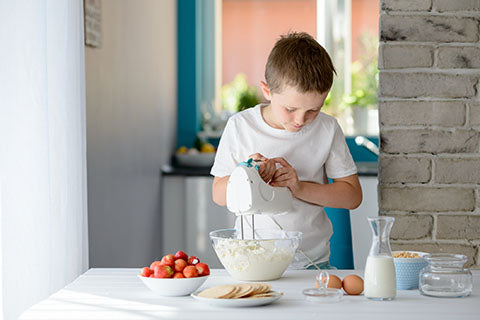 Kid cooking with mixer