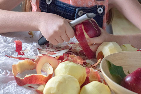 Kid peeling apple