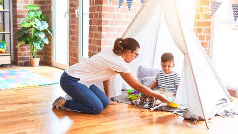 Boy playing in Montessori teepee