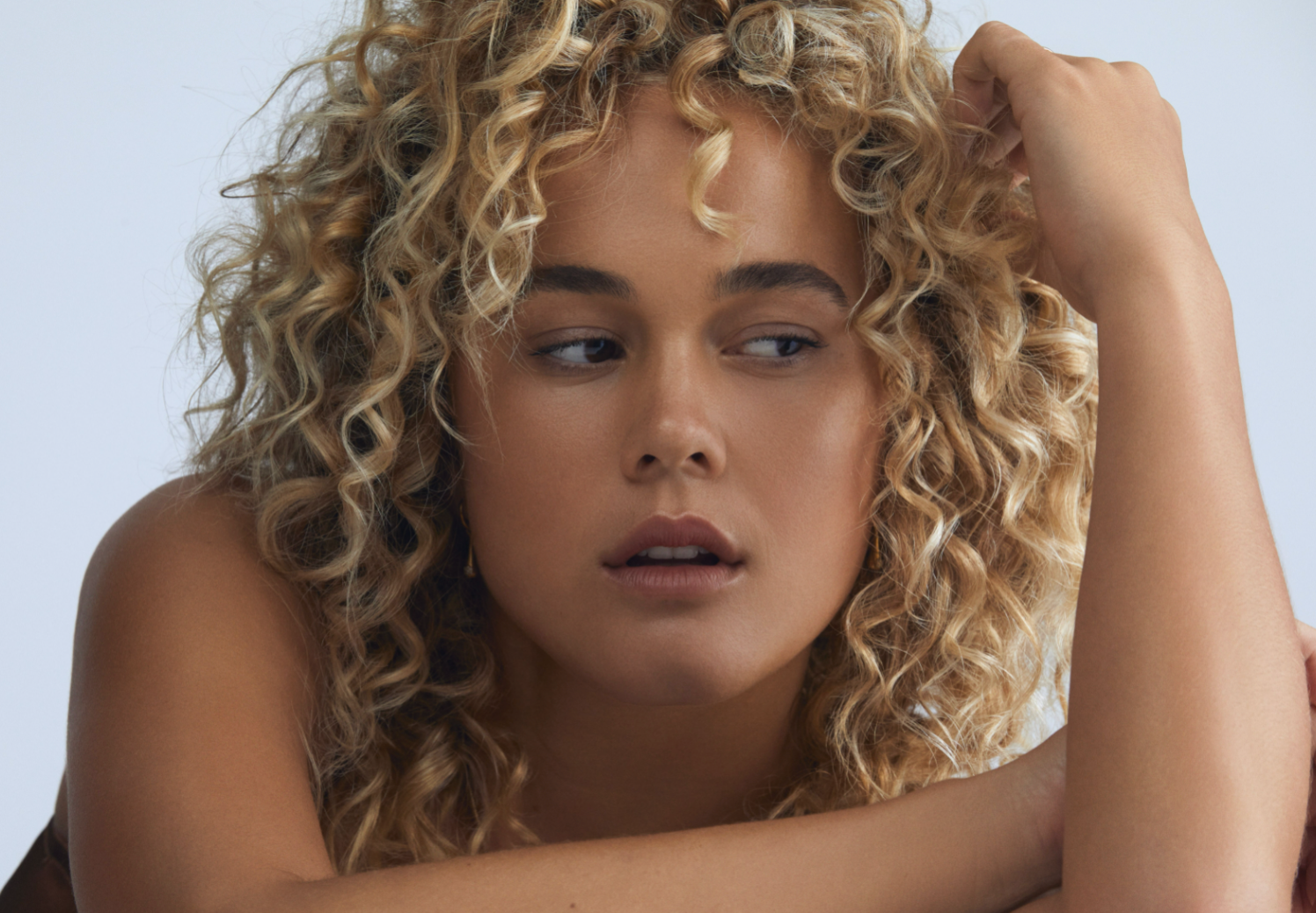 Curly Hair Care - Blonde Girl with Curly Hair