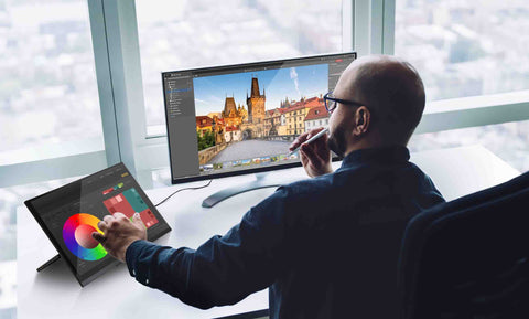 Man working in the office with his SideTrak Solo freestanding touchscreen portable monitor