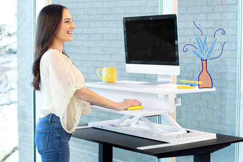 woman using her Stand Steady standing desk while working