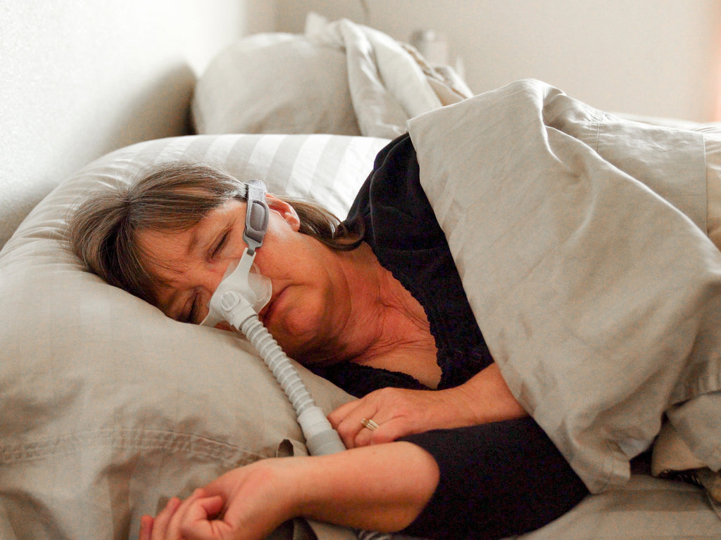 Person using CPAP Machine to help them sleep