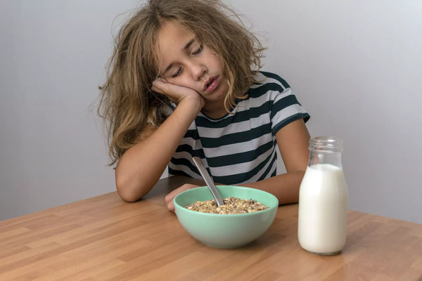 Sleepy Child Eating Cereal