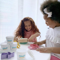 two little girls playing with dough