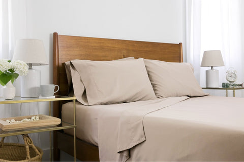 A made bed with tan sheets from Southshore Fine Linens.