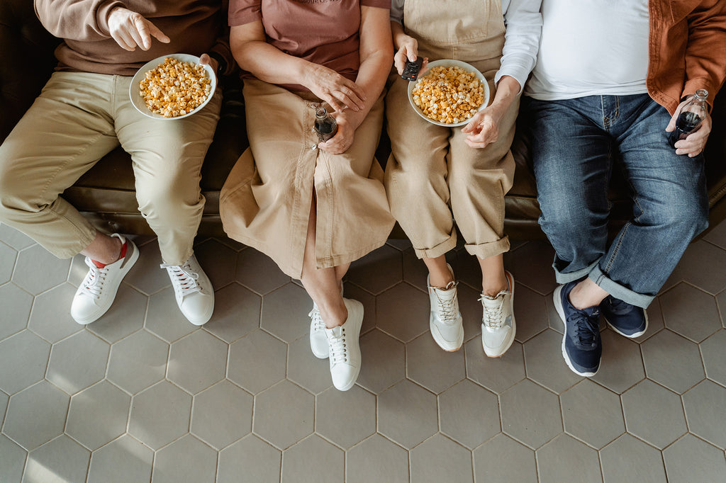 People Sitting on a Couch with Popcorn