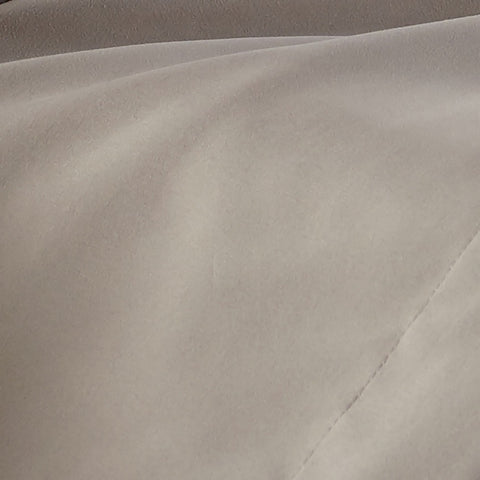 A closeup on tan bed sheets from Southshore Fine Linens.