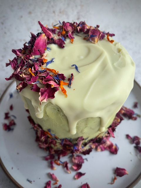 matcha roll cake with white chocolate, sprinkled with edible flowers
