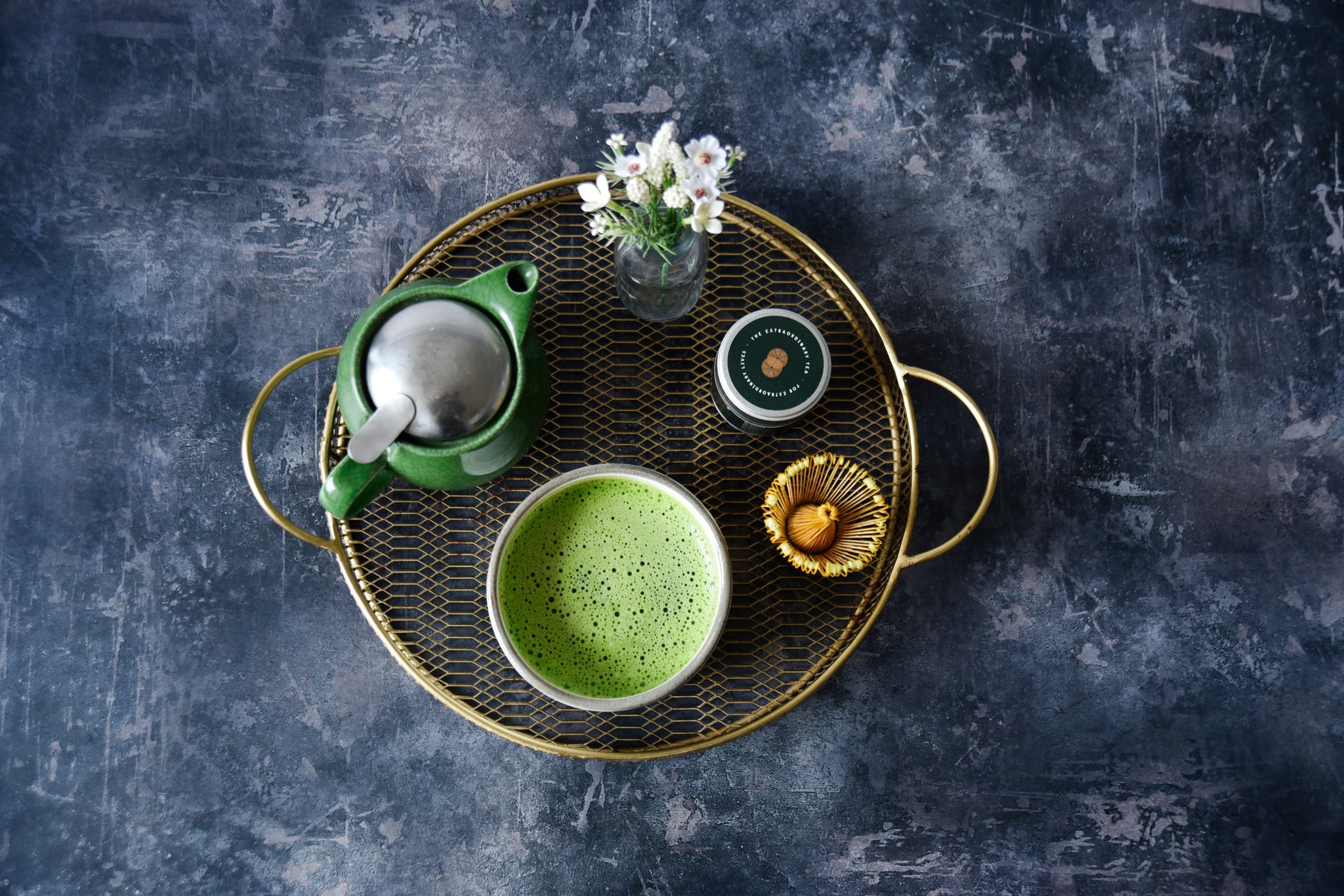 brass tray with teapot bowl of matcha and bamboo whisk 