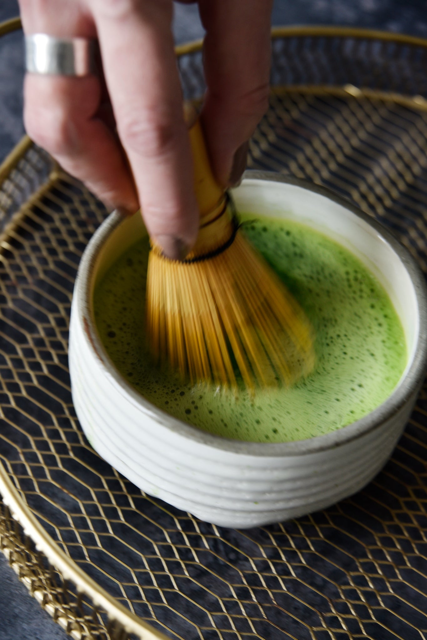 matcha in a bowl being whisked