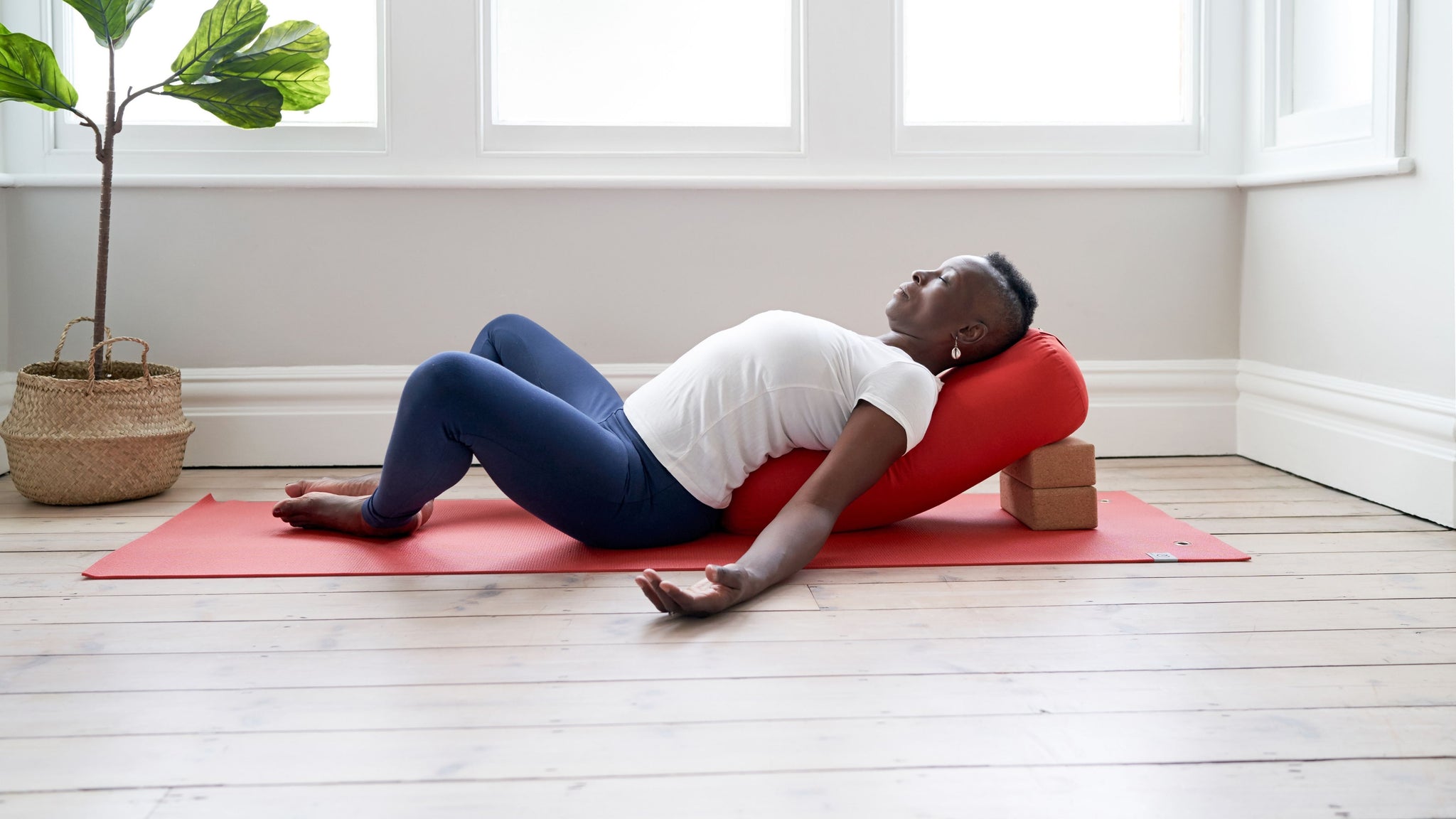 woman doing yoga pose on back