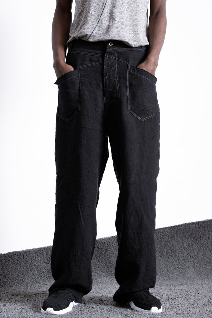 Black baggy trousers for men and women with a low crotch and wide leg. Discover Marshall online at eigensinnig wien. Concept store for avant-garde fashion in black. express delivery