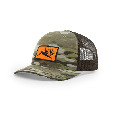 We The Essentials Multicam Black Trucker Hat with Orange Patch