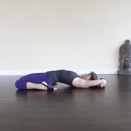 Young attractive woman practicing yoga, lying in Reclining Hero exercise,  Supta Virasana pose, working out wearing sportswear, blue suit, indoor full  length, white studio background Stock Photo | Adobe Stock