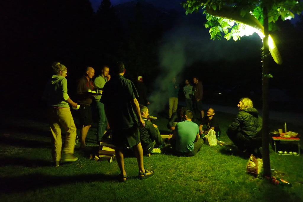 Packrafters standing around the fire