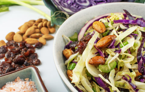 Almond and cranberry coleslaw in bowl on table