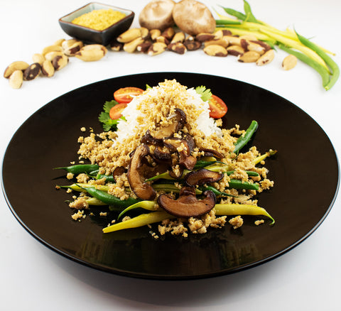 Brazil Nut Parmesan on shitake and beans with rice on a plate