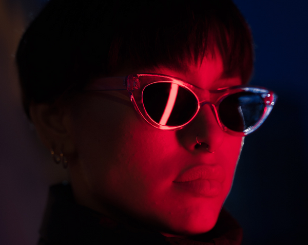 Woman with sunglasses in red light