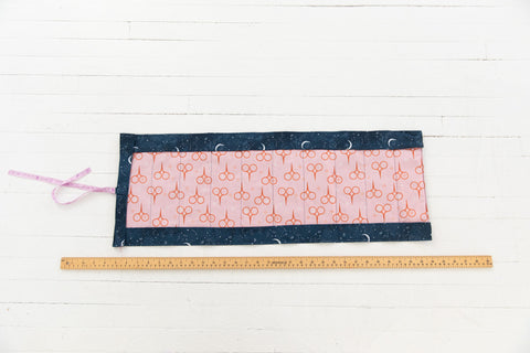 Opened needle roll, showing the flaps and spaces for needles.