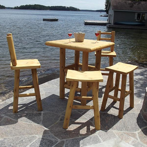 square high top pub table with barstools on patio stone next to the lake.
