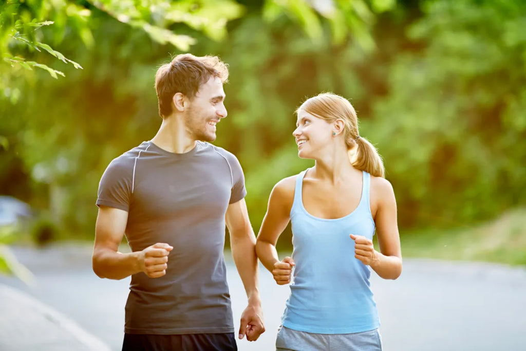 a man and woman couple brisk walking for joint health