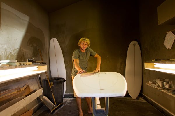 Tyler Warren shaping a surfboard