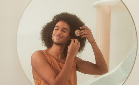 Homem com cabelo cacheado utlizando um shampoo B.O.B