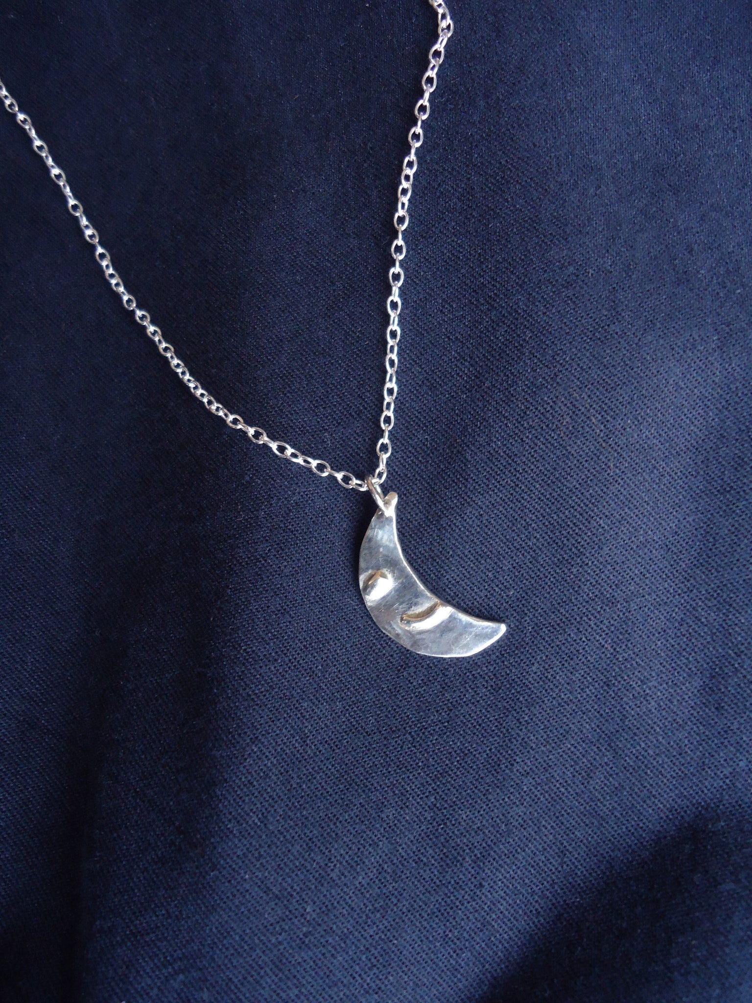 blue crescent moon with face