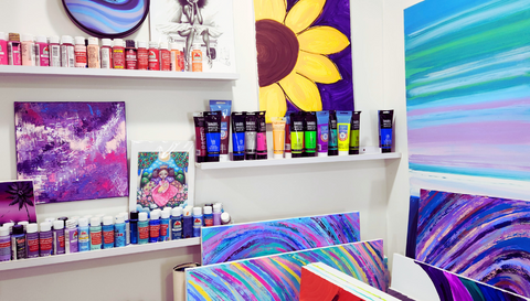 Corner of art studio with paint storage on the walls