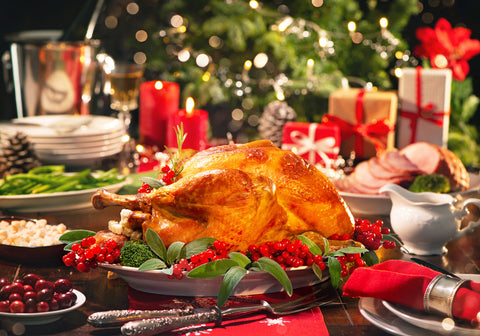 Close up image of a roasted Christmas turkey on a Christmas table setting