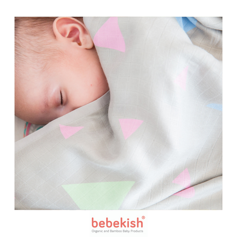 Baby sleeping with a swaddle