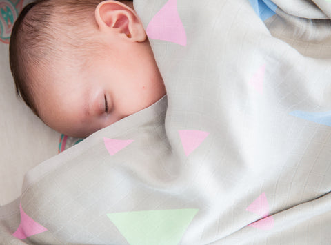 Baby is sleeping with Bebekish bamboo muslin swaddle 