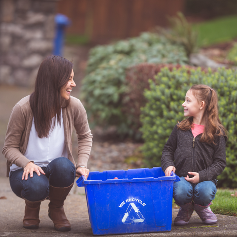 mum is teaching a child recycling