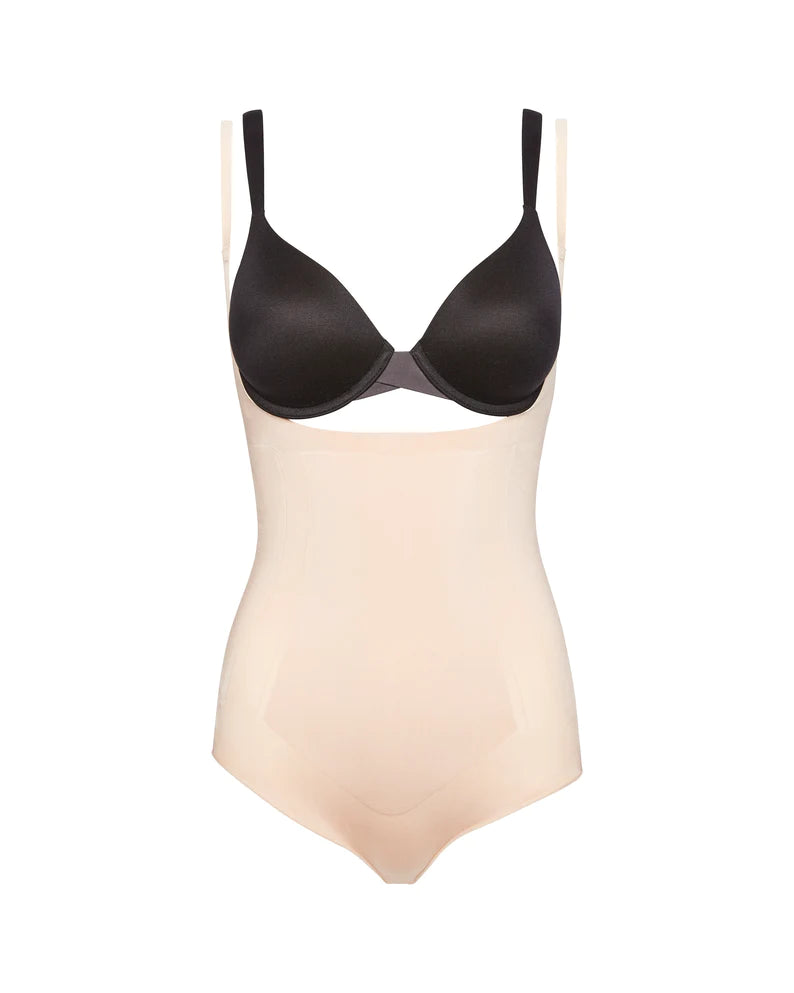 The OnCore Open-Bust Panty Bodysuit from Spanx in Soft Nude