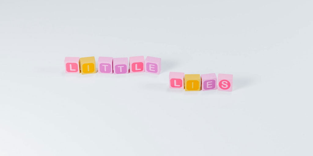 Colorful blocks of letters arranged to spell out the phrase little lies. Photo by Pawel Czerwinski Unsplash