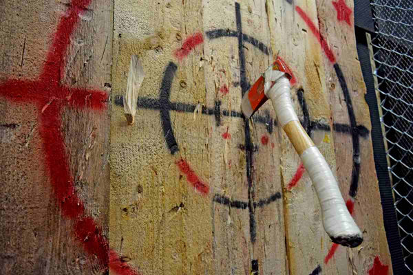 An axe hitting the bullseye in a throwing competition