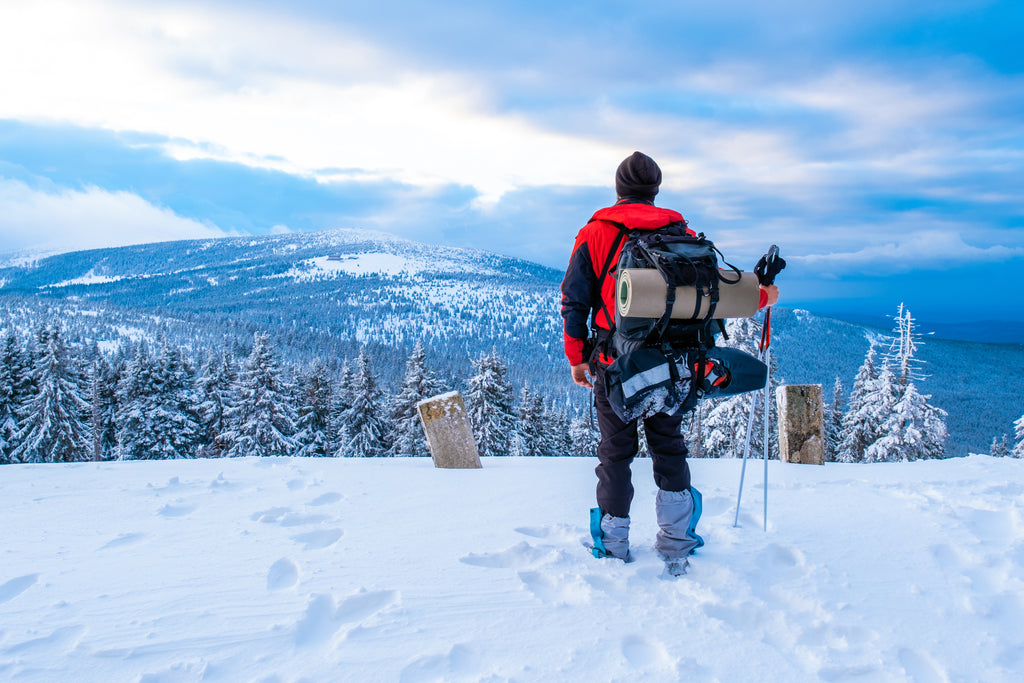 man on top of a snowy mountain