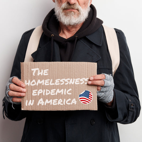 homeless man holding a sign