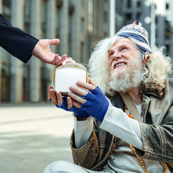 homeless man receiving food from a stanger