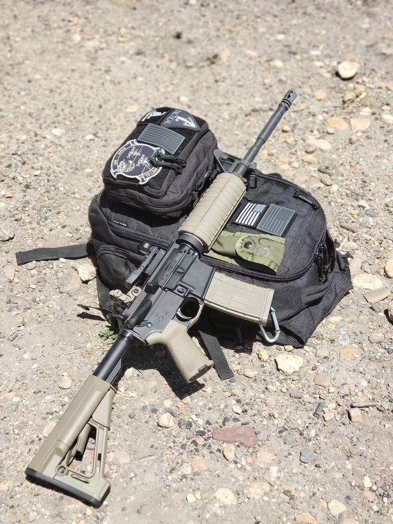 Visual representation of readiness: Tactical backpack and firearm on the ground.